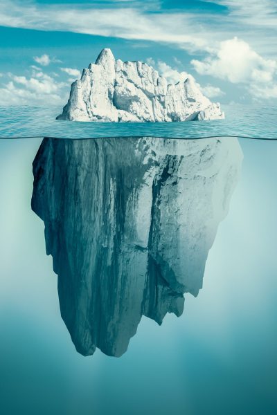 Iceberg in ocean as hidden threat or danger concept